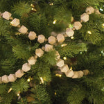 Yuletide garland on Christmas tree with lights