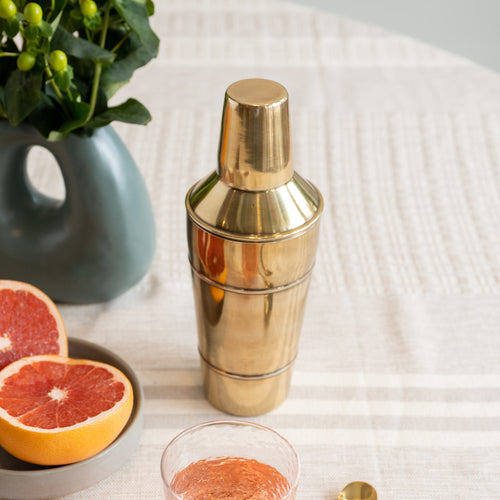Orion cocktail shaker on table with grapefruit